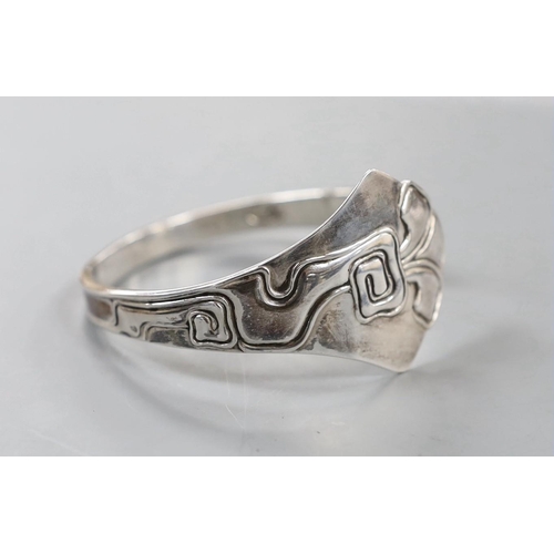 916 - An early 20th century Danish sterling openwork bangle, dated for 1911, with later engraved inscripti... 