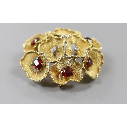 935 - A 1960's textured 18ct gold, garnet and diamond cluster set open work flower head brooch, maker C.V.... 