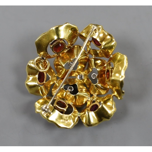 935 - A 1960's textured 18ct gold, garnet and diamond cluster set open work flower head brooch, maker C.V.... 