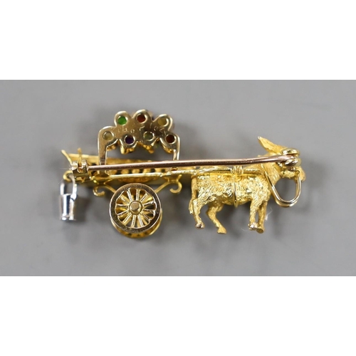 938 - A modern yellow metal hinged bangle with Greek Key decoration and a 9ct donkey and cart charm, gross... 