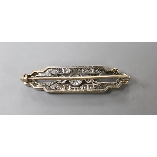 947 - An Art Deco 18ct, plat and diamond cluster shaped bar brooch, with millegrain set stones, 37mm, gros... 