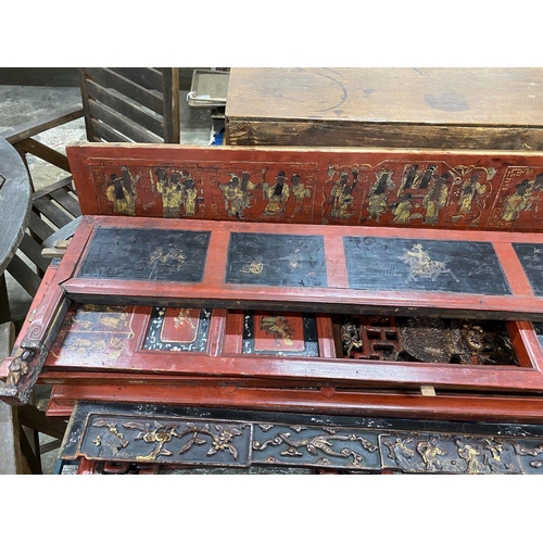 1028 - Nine sections of a Chinese red lacquered cabinet, with gilt figural decoration