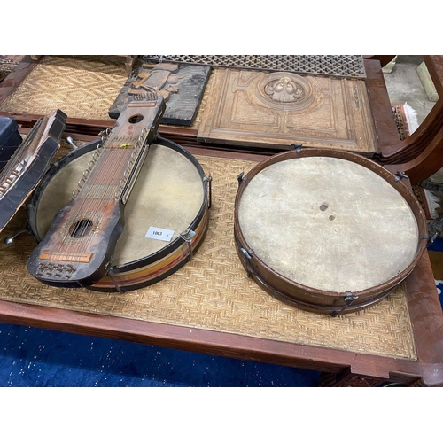 1063 - A group of assorted musical instruments comprising two large tambourines, two zithers and a Zenith t... 