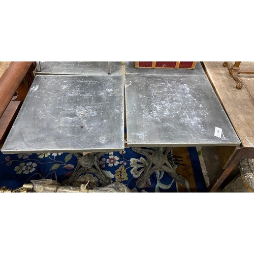 1067 - A pair of zinc topped cafe tables with cast iron bases, width 60cm depth 60cm height 74cm