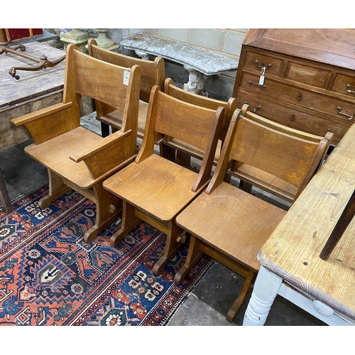 1072 - A set of six Gothic style oak dining chairs including a pair of carvers