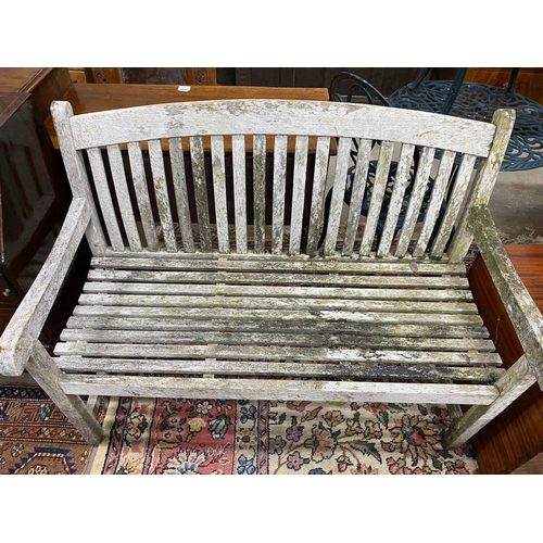 1078 - A weathered teak garden bench, width 120cm