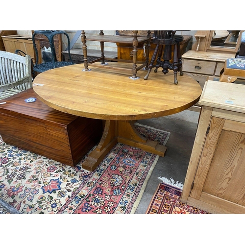 1080 - A 'Woodpecker Man' adzed oak dining table, with oval top and chip carved underframe, 170cm x 146cm... 