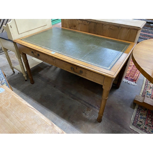 1084 - An early 20th century oak writing table, width 137cm