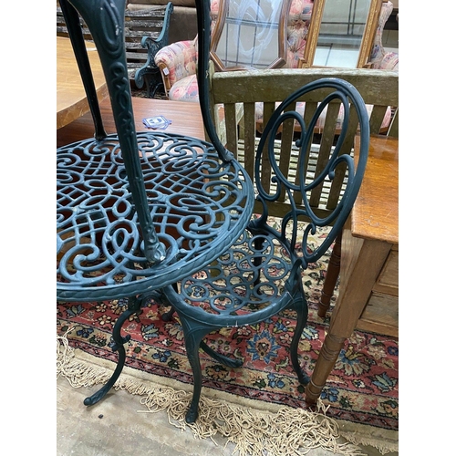 1088 - A green painted aluminium cafe table and two chairs