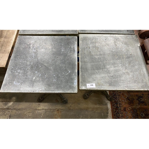 1096 - A pair of zinc top cafe tables with cast iron underframes, 60 x 60cm