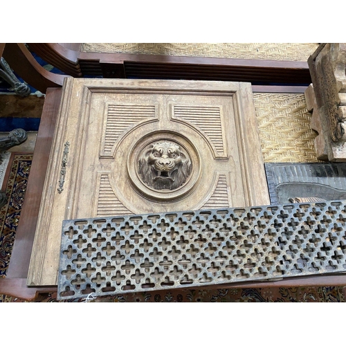 1098 - An Asian hardwood low seat, a relief carved panel, a lion's mask carved door and a cast iron grate... 