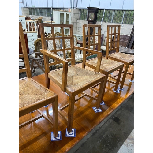 1100 - A set of five Heals Cotswold oak dining chairs, including one carver