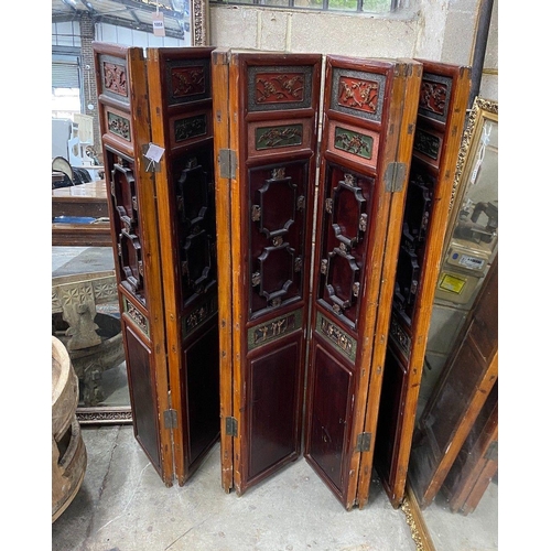 1101 - A Chinese painted carved and pierced wood seven fold screen, height 142cm