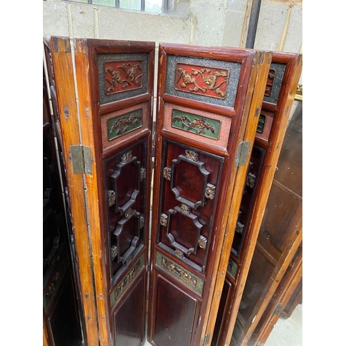 1101 - A Chinese painted carved and pierced wood seven fold screen, height 142cm