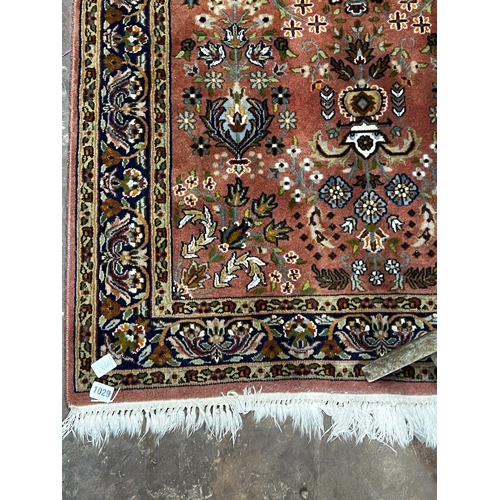 1107 - A North West Persian peach ground rug, 160 x 93cm