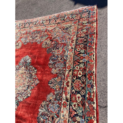 1120 - A large North West Persian red ground carpet, 361cm x 274cm