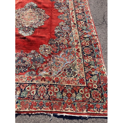 1120 - A large North West Persian red ground carpet, 361cm x 274cm