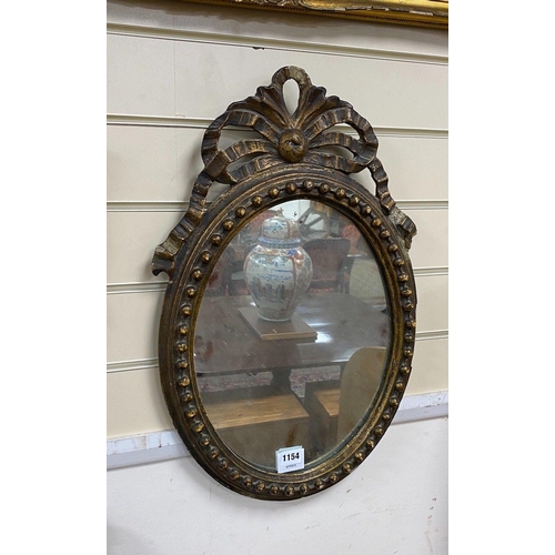 1124 - A 19th century giltwood and gesso oval wall mirror, height 59cm