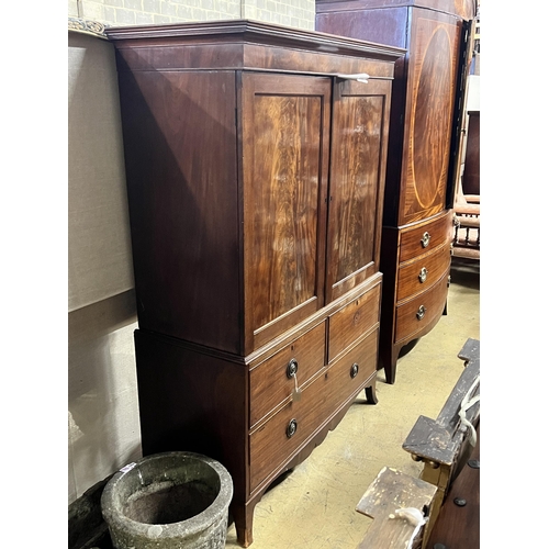 1003 - A George III mahogany linen press converted to a hanging wardrobe with part dummy drawer front, widt... 