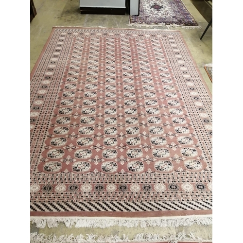 1016 - A pair of Bokhara peach ground carpets, 310 x 218cm