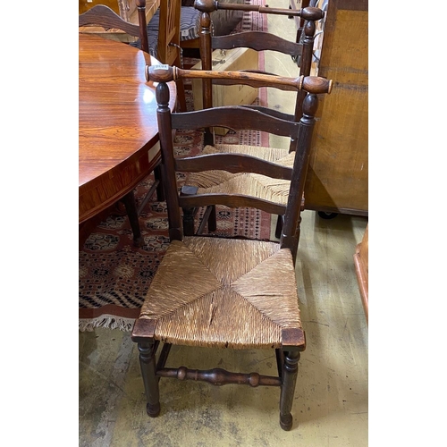 1036 - A set of six rush seated ladderback dining chairs