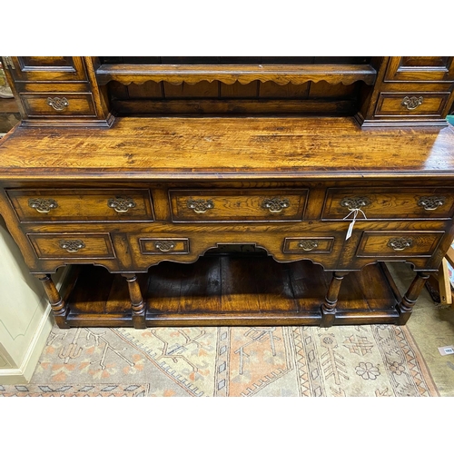 1051 - An 18th century style mahogany banded oak potboard dresser with boarded rack, width 167cm, depth 48c... 