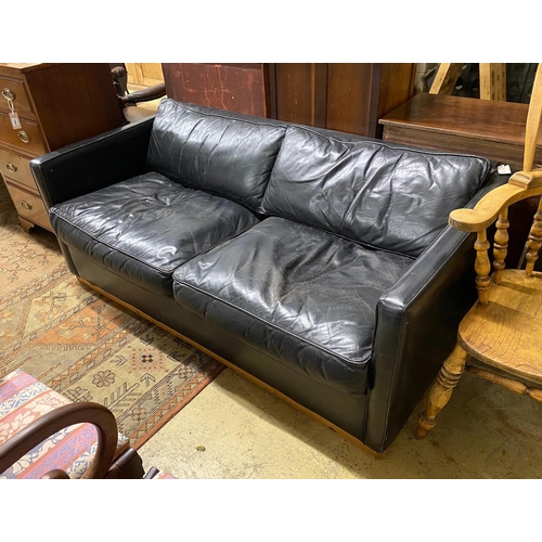 1095 - A black leather upholstered two seater sofa bed, length 172cm