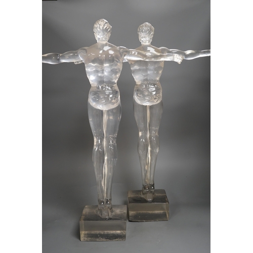 1357 - A pair of clear perspex models of male swimmers, 57cms high,