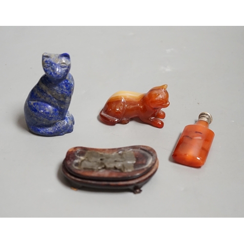 1463 - A Chinese carved lapis lazuli seated cat, a banded agate recumbent cat on hardwood stand and a white... 