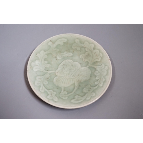 1464 - A Chinese carved celadon dish, Qing dynasty, 15cm diameter