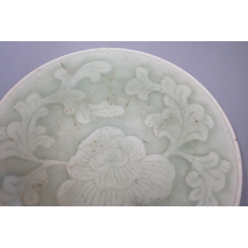 1464 - A Chinese carved celadon dish, Qing dynasty, 15cm diameter