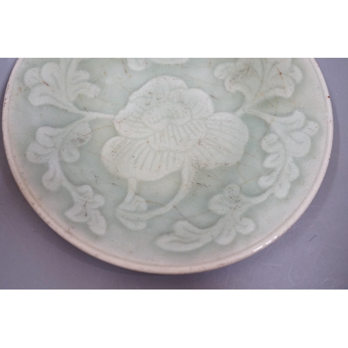 1464 - A Chinese carved celadon dish, Qing dynasty, 15cm diameter