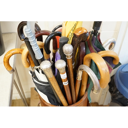 1470 - Four assorted white metal mounted walking sticks, sundry walking sticks, umbrellas and canes,