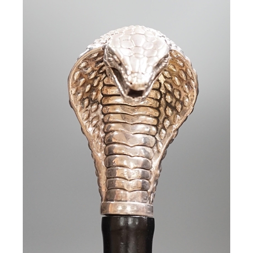 1477 - A Jeffery West umbrella with silver cobra handle,94cmslong