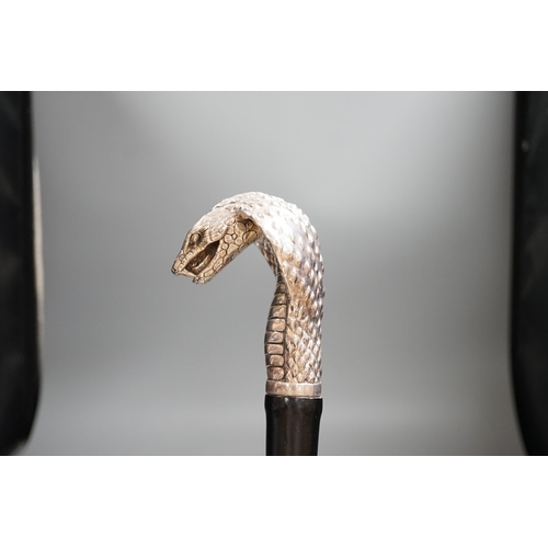 1477 - A Jeffery West umbrella with silver cobra handle,94cmslong