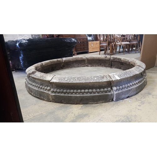 1001 - A reconstituted stone circular sectional garden planter, each segment width 68cm, height 28cm