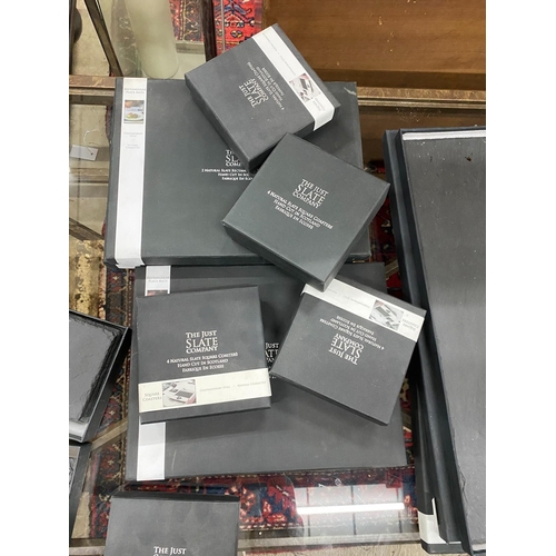 102 - A quantity of 'The Just Slate Company' table mats, runners and coasters, all boxed