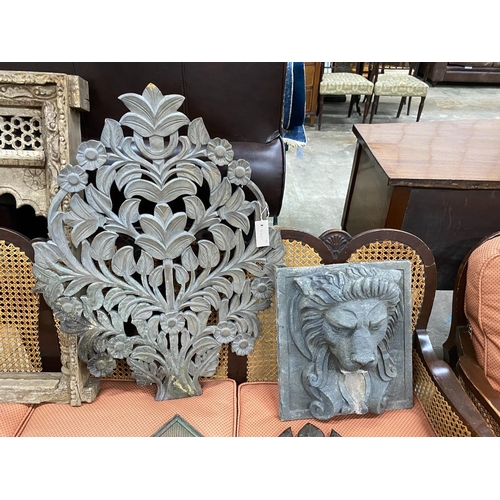 122 - A carved Eastern hardwood window frame, height 82cm, a composition lion mask wall fountain two spoon... 