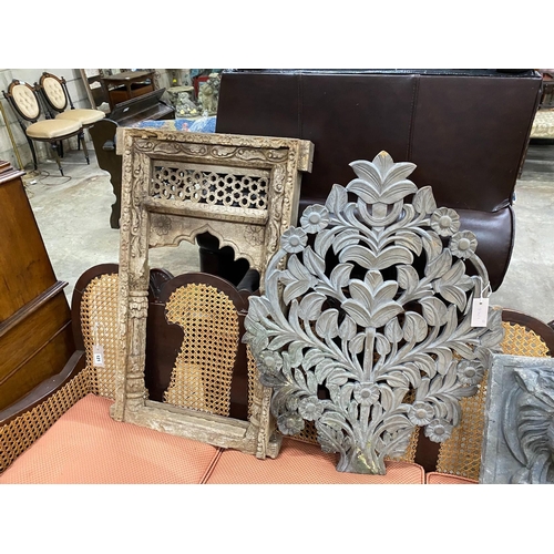 122 - A carved Eastern hardwood window frame, height 82cm, a composition lion mask wall fountain two spoon... 