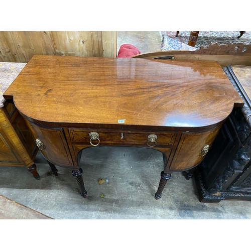 137 - A Regency mahogany bow fronted sideboard, on reeded legs, width 136cm, depth 70cm, height 94cm... 