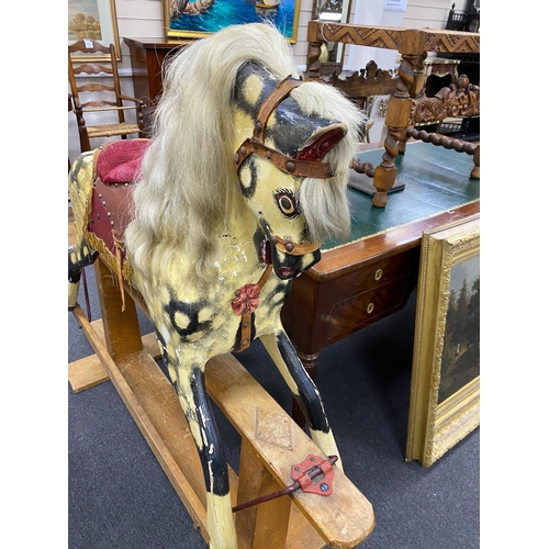 157 - A mid 20th century Ayres type dapple rocking horse on pine safety frame height 122 cms