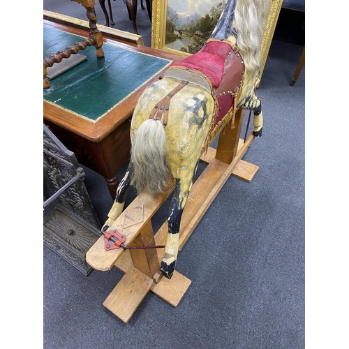 157 - A mid 20th century Ayres type dapple rocking horse on pine safety frame height 122 cms