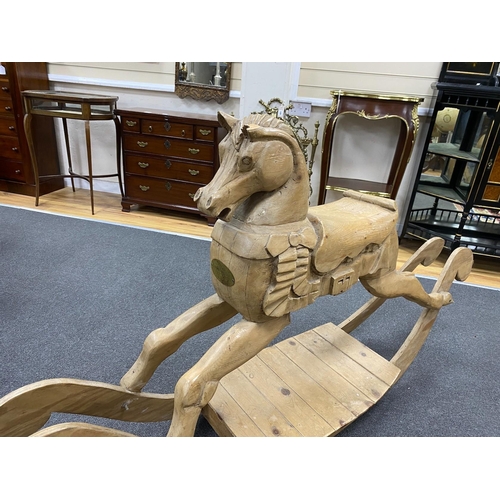 164 - A carved pine rocking horse, height 93cm.