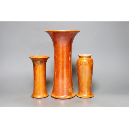 250 - A group of three Ruskin orange lustre vases, largest 25cm