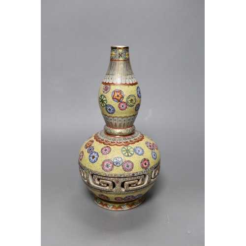 251 - A Chinese enamelled porcelain double walled rotating vase, 24cm