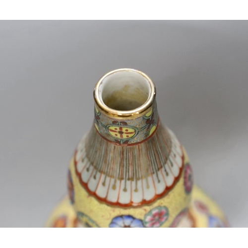 251 - A Chinese enamelled porcelain double walled rotating vase, 24cm