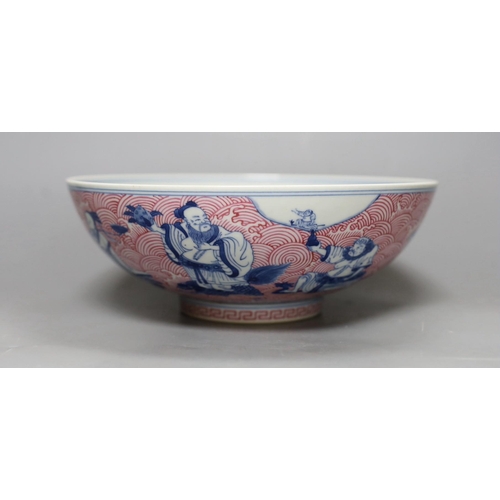 252 - A Chinese underglaze blue and puce enamelled 'eight immortals' bowl, 22cm diameter