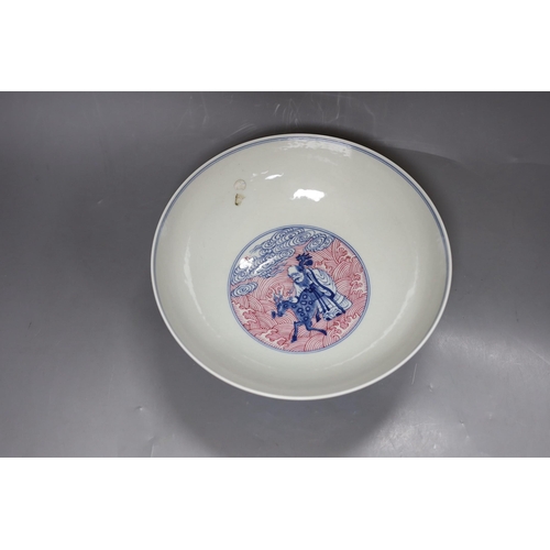 252 - A Chinese underglaze blue and puce enamelled 'eight immortals' bowl, 22cm diameter