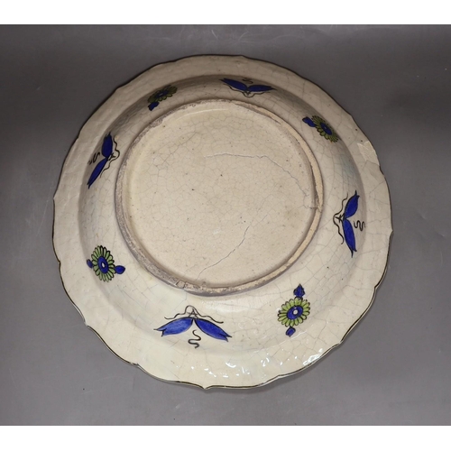 281 - A large Persian fritware charger, in Iznik style, 36cm