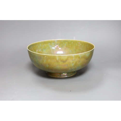 285 - A Ruskin thinly potted green and ochre lustre fruit bowl, dated 1923, 25cm diameter